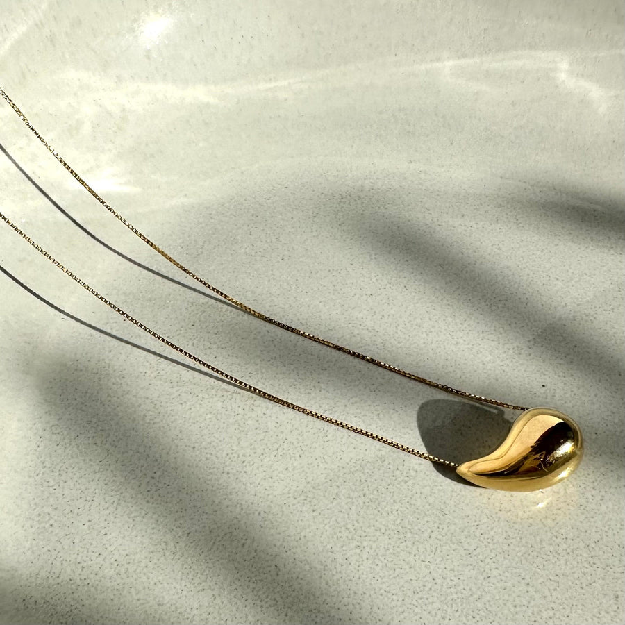 Necklace with thin silver chain and teardrop pendant