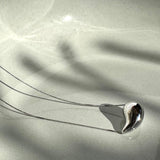 Necklace with thin silver chain and teardrop pendant