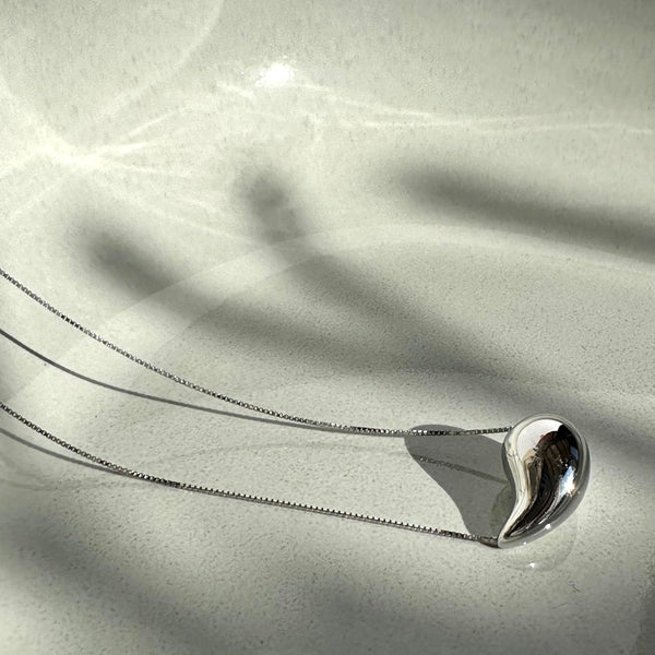 Necklace with thin silver chain and teardrop pendant